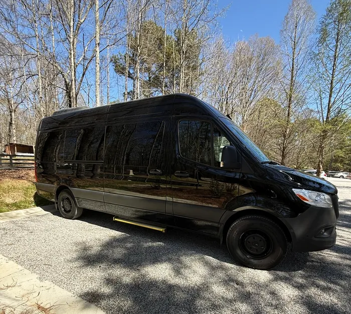 Black Mercedes-Benz Sprinter van, side view