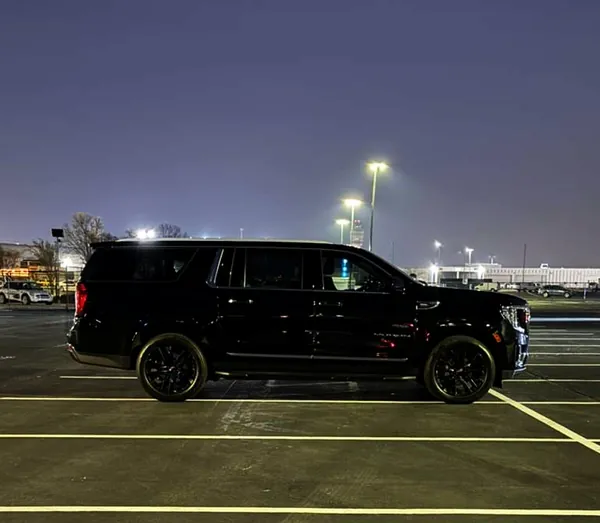 Black GMC Yukon XL at night